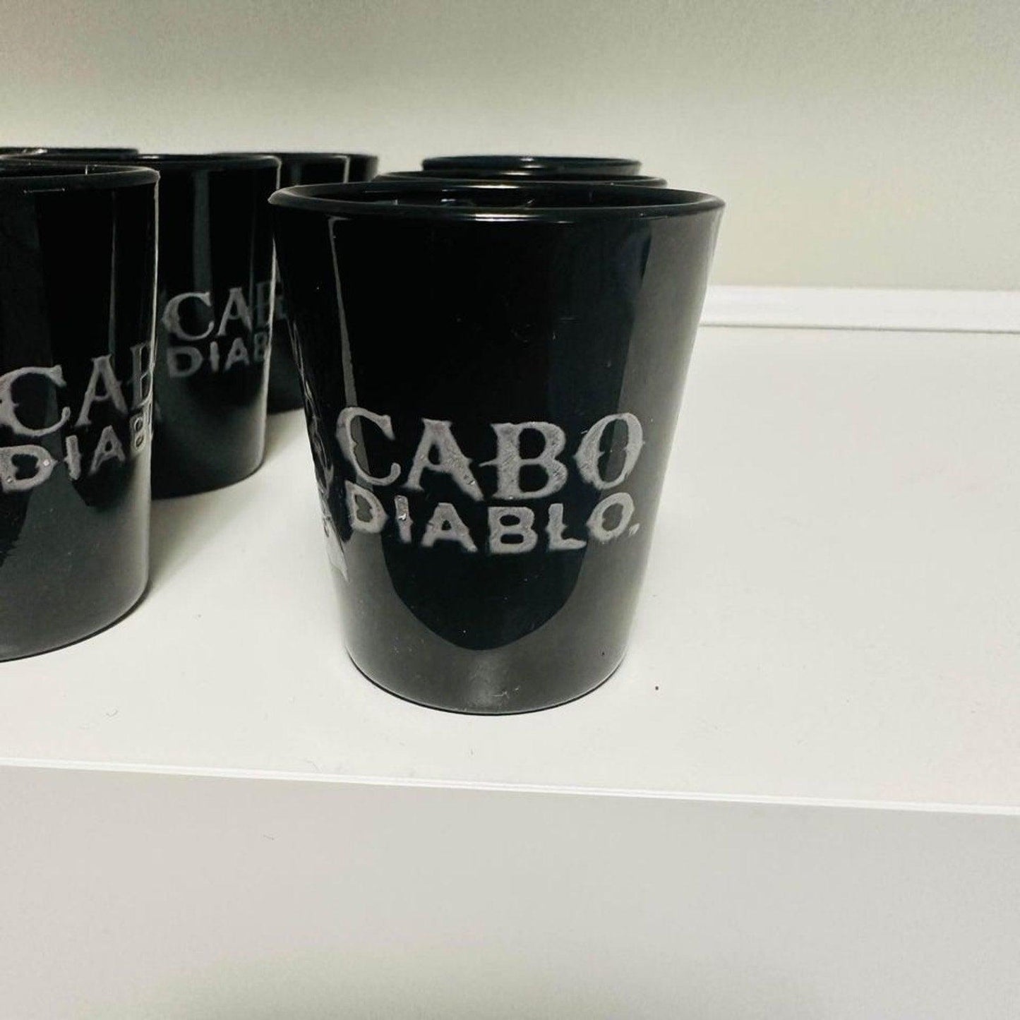 A set of 12 Cabo Diablo tequila shot